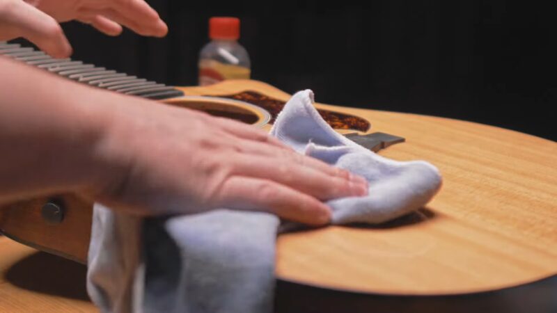 Wiping the guitar with a cloth after use