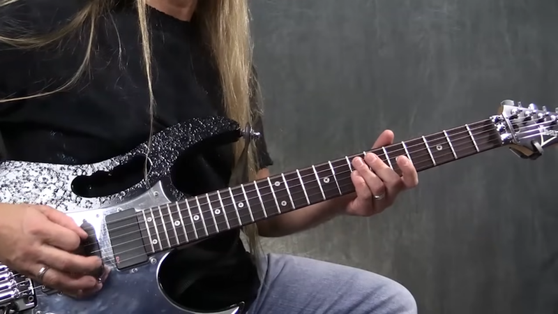 A Person Plays a Silver Sparkle Electric Guitar, Demonstrating Basic Picking Exercises