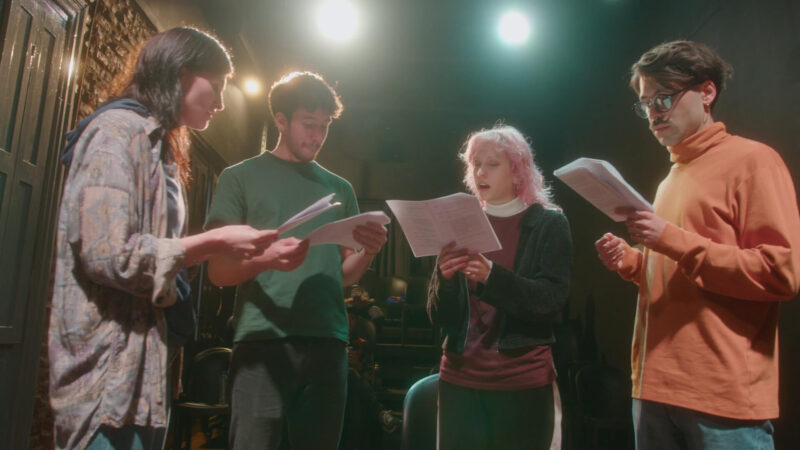 A rehearsal of a choir consisting of four people