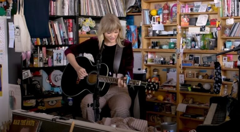 Taylor Swift playing a guitar