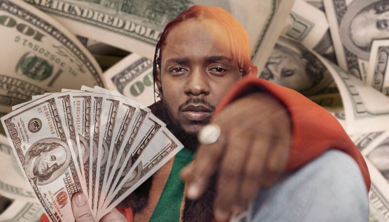 Kendrick Lamar holding a fan of hundred-dollar bills with a background of money