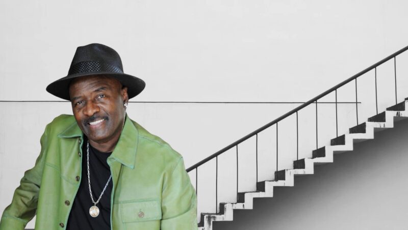 Walter Williams poses for picture with house stairs behind him