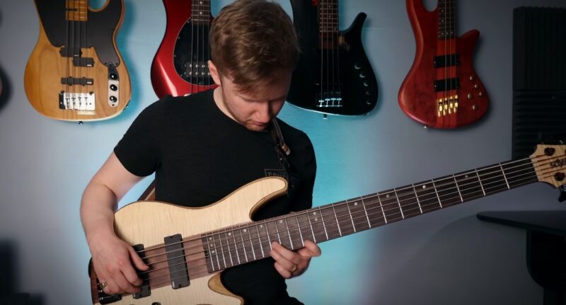 Musician engrossed in playing a bass guitar