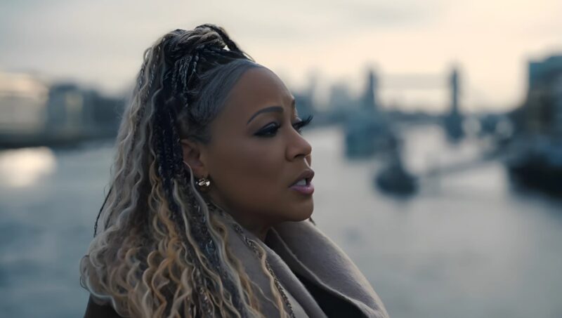 Erica Campbell, thoughtful and poised, gazes out at the London skyline