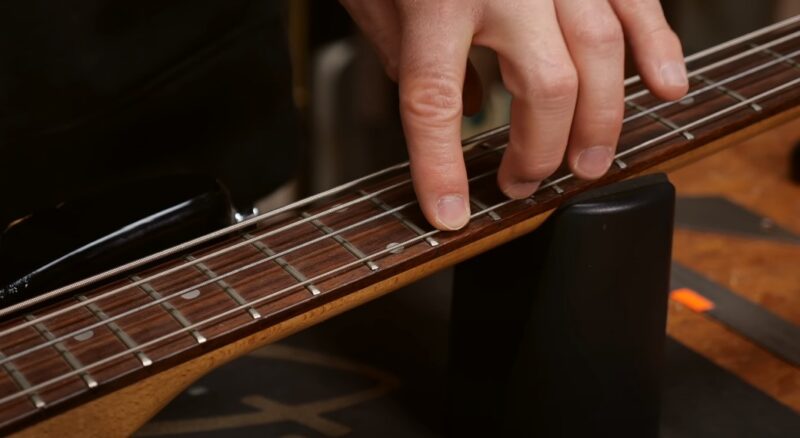 Close-up view of a bass guitar fretboard