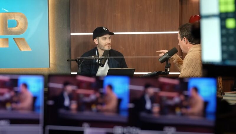 Two podcast hosts engaged in lively discussion