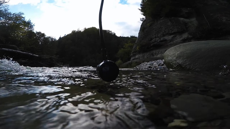 Underwater microphone (hydrophone) placed in a shallow river, capturing aquatic field recordings in nature