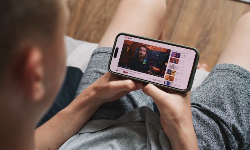 A person looking at a YT video