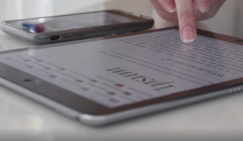 Focused finger tracing digital text, a moment of intense concentration
