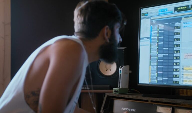 Close-up view of a professional audio engineer at work in a recording studio