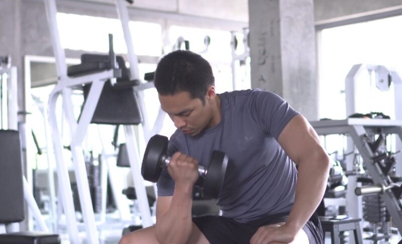 Man performing a bicep curl with dumbbells