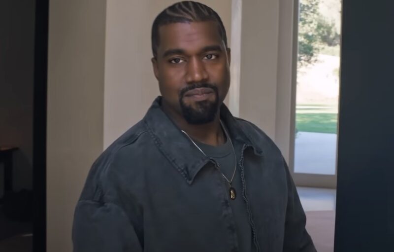 Kanye West standing on the house entrance