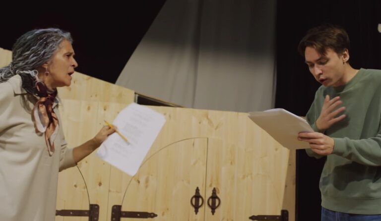 Two actors engrossed in a rehearsal, lines exchanged with intensity