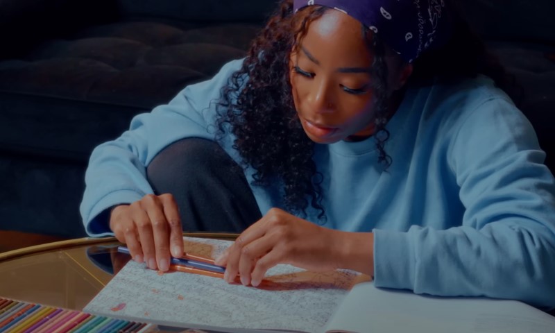 Woman having fun with adult colouring game