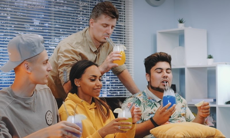 Friends enjoying colorful drinks and good company