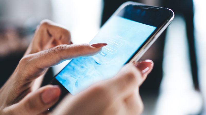 A celebrity manager using a smartphone to manage tasks and communication in the afternoon