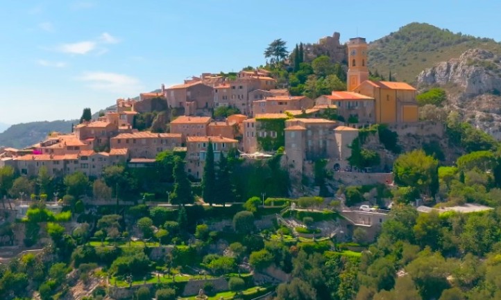 Village of Èze perched dramatically on a rocky outcrop beneath a bright blue sky