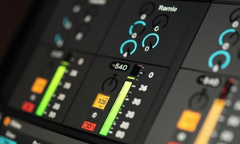 Close-up of a mixing board featuring numerous knobs for audio control and adjustment