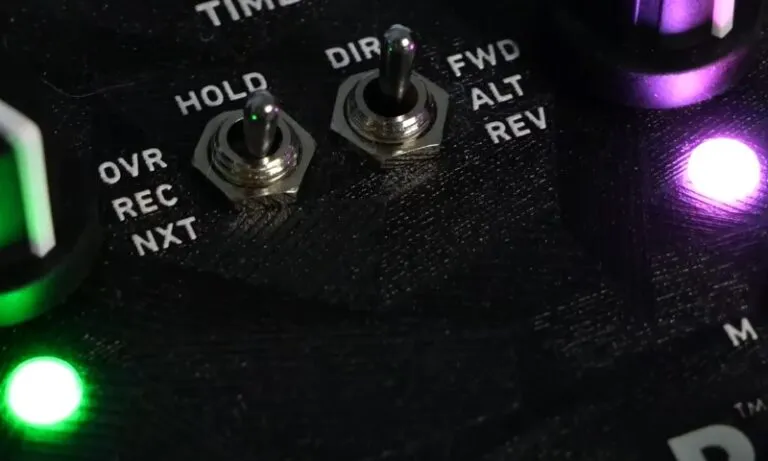 Close-up of a guitar pedal featuring multiple knobs for adjusting sound effects and settings